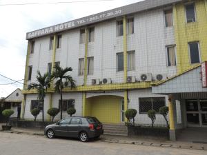 a car parked in front of a building at HOTEL SAFFANA in Douala