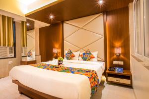 a bedroom with a large bed in a room at FabHotel Spring Inn Kandivali in Mumbai