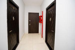 a hallway with two doors and a red fire hydrant at Kristal Absheron in Baku