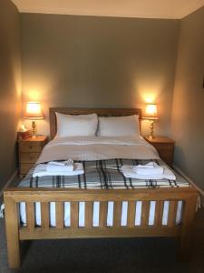 a bed with a white bedspread and pillows at Ivy Braveheart Guest House in Edinburgh