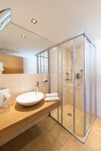 a bathroom with a sink and a shower at Der Winklhof in Saalfelden am Steinernen Meer