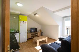 a kitchen and a living room with a white refrigerator at LA CASA DE LUIS Garaje Incluido in Zamora