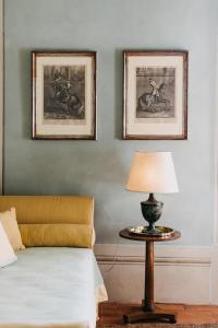 a bedroom with a bed and a table with a lamp at Palazzo Feroci - Residenza d'epoca in Pisa