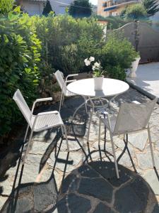 three chairs and a table and a table and chairs at Cap d Antibes, Salis beach , 2 bedrooms , free parking in Antibes