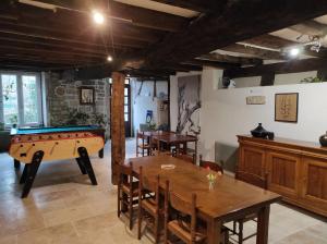a room with a table and a pool table at Le Moulin Aux Ecrevisses in Thonnance-lès-Joinville