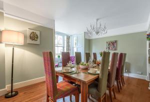 a dining room with a table and chairs at Maltings House in Milton Abbas