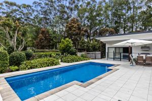 a swimming pool in the backyard of a house at The Castle at Bonville in Bonville