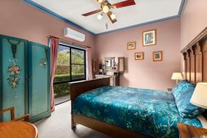 a bedroom with a bed and a window at The Castle at Bonville in Bonville