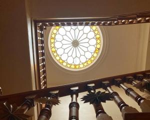 a mirror with a circular window on the ceiling at Heathpark House in Blairgowrie