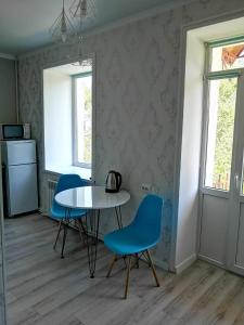 a dining room with a table and two chairs at Happy House in Karagandy
