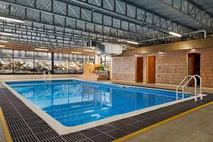 a large swimming pool in a building at Super 8 by Wyndham Hearst ON in Hearst