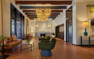 a living room with a chandelier and a fireplace at Mar Monte Hotel, in The Unbound Collection by Hyatt in Santa Barbara