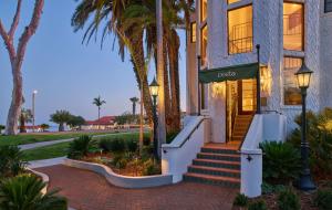 a house with palm trees in front of it at Mar Monte Hotel, in The Unbound Collection by Hyatt in Santa Barbara