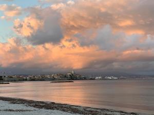 a cloudy sky over a body of water at Cap d Antibes, Salis beach , 2 bedrooms , free parking in Antibes
