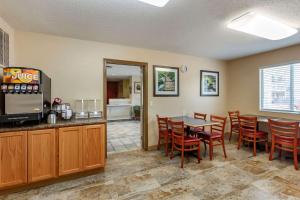 a dining room with a table and chairs at Econo Lodge in Belle Fourche