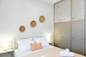 a bedroom with a white bed with white pillows at Θἔρως (Theros) house 1 - Agios Fokas in Tinos