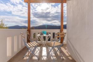 a table and chairs on a balcony with a view at Traditional House @ Chora Astypalea in Astypalaia Town
