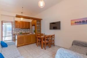 a living room with a table and a kitchen at Traditional House @ Chora Astypalea in Astypalaia