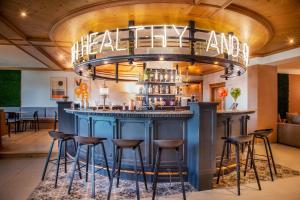 a blue bar with stools in a restaurant at Victoria Hotel & Residence in Villars-sur-Ollon