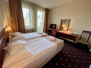 Postel nebo postele na pokoji v ubytování Hotel Seven + 37 fotografií