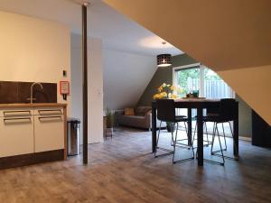 cocina y comedor con mesa y sillas en De Gorzen, en Oud-Turnhout