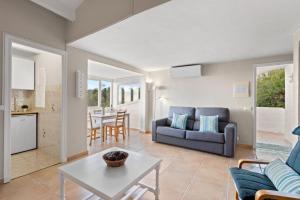 a living room with a couch and a table at Apartamento Cap Roig in Binibeca
