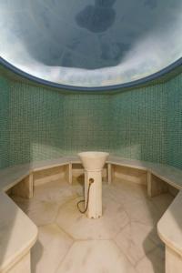 
a bathroom with a toilet and a bath tub at Aegean Pearl in Rethymno Town
