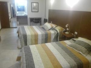 Una cama o camas en una habitación de Hotel Americano Pergamino