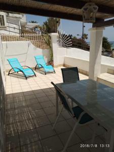 a patio with two blue chairs and a table at MOJACAR PLAYA in Mojácar