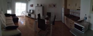 a living room with a couch and a kitchen at MOJACAR PLAYA in Mojácar +11 photos