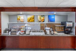 a breakfast counter in a hotel room with food at Comfort Inn Paramus - Hackensack in Paramus