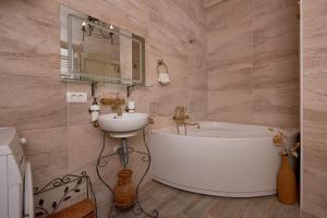 a bathroom with a bath tub and a sink at Perfetto Perasto Residence in Perast +44 photos
