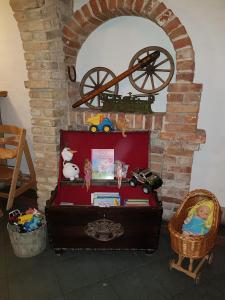 a room with a brick wall with a table with toys at Ritterhof Kampehl in Neustadt