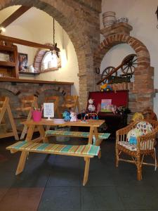 a table and chairs in a room with a stone wall at Ritterhof Kampehl in Neustadt