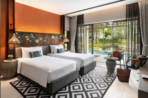Postel nebo postele na pokoji v ubytování Grand Mercure Khao Lak Bangsak