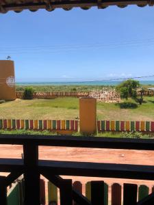 a fence with a view of a city at Costa Marlin Hotel in Guriri