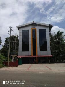 a building on the side of a street at Adheesh Lodge in Dharmastala