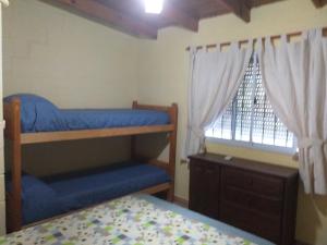 1 dormitorio con 2 literas y ventana en Cabanas Valle Azul en Villa Rumipal