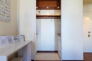 a kitchen with a white refrigerator and a desk at Duomo Luxury Apartment VII in Milan