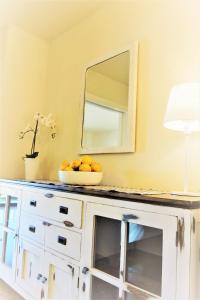un tazón de naranjas en una cómoda blanca con espejo en Port de Sóller Promenade Apartment., en Puerto de Sóller