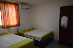 Postel nebo postele na pokoji v ubytování Hostal El Naufrago 1