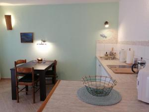 a kitchen with a table and a dining room at Apartments Kuća Nebeska in Viganj