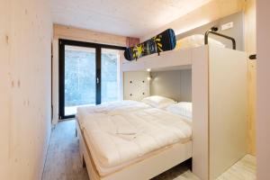 a bedroom with a bunk bed and a large window at Oberstdorf Hostel in Oberstdorf