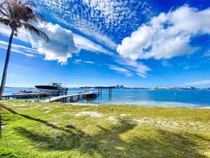 una spiaggia con molo, palma e barca di Villa Marie, swimming pool, beach, pontoon and jacuzzi, all private a Baie Nettle