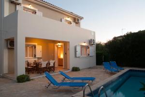 Villa mit einem Pool und blauen Stühlen in der Unterkunft Family Villa with Pool in Zakynthos in Zakynthos