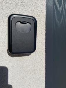 a black box on the side of a wall at The Corner House - Modern Chesterfield Town Centre Apartments in Chesterfield