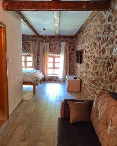 a living room with a couch and a bedroom at Apartment Old House in Podgorica