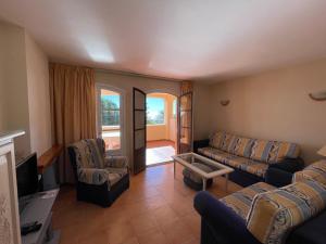 a living room with a couch and two chairs at Apartamentos El Toro in Marbella