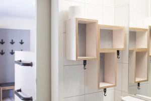 a bathroom with wooden cupboards in a room at Oberstdorf Hostel in Oberstdorf