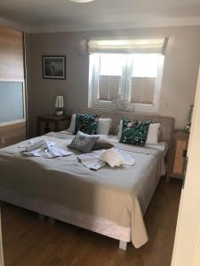 a bedroom with a large bed with towels on it at Magister Wigbold 22 in Zingst